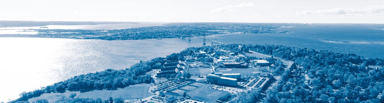 Aerial view of campus approaching the Mount Hope Bay