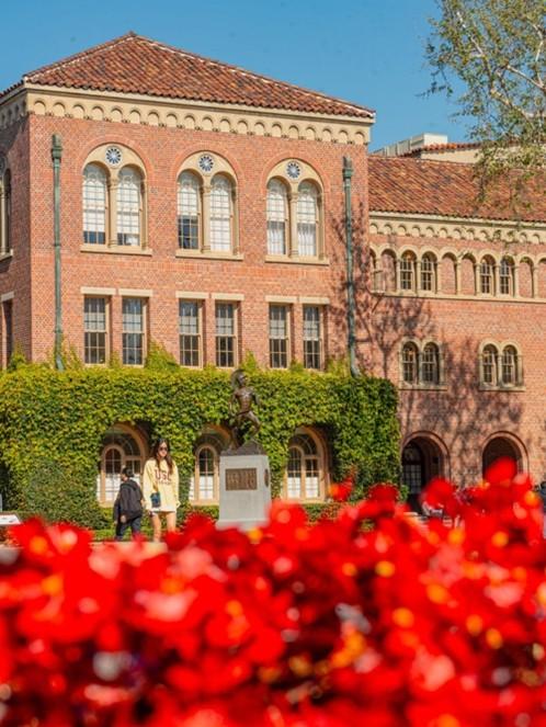 Building with greenery and flowers in front
