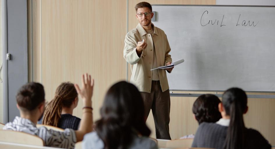 A teacher instructs a classroom of students