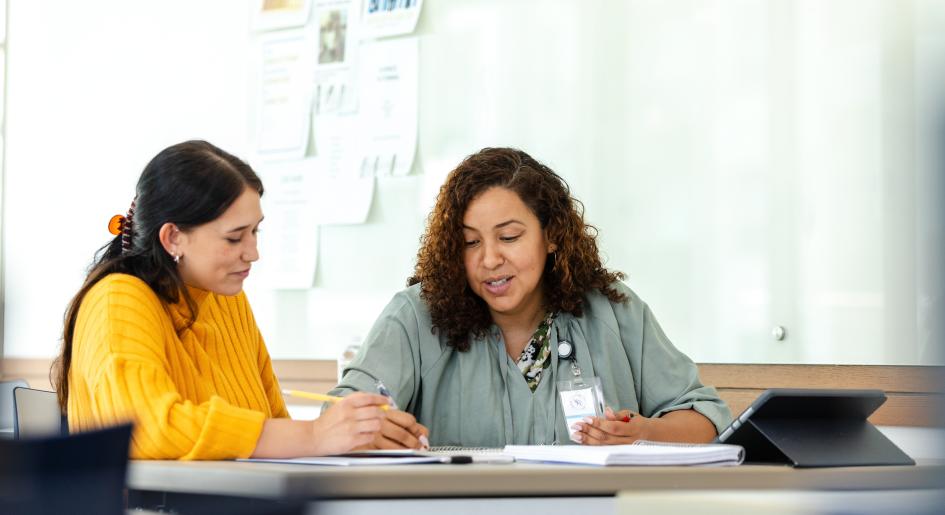 Two women sit together at a table