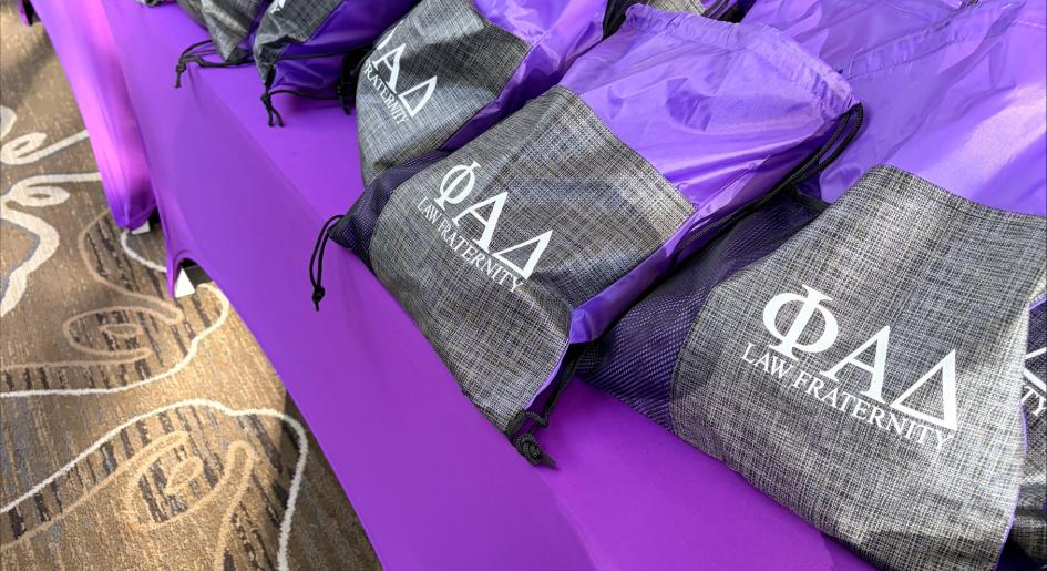 A row of bags sitting on a table. The bags say "PAD".