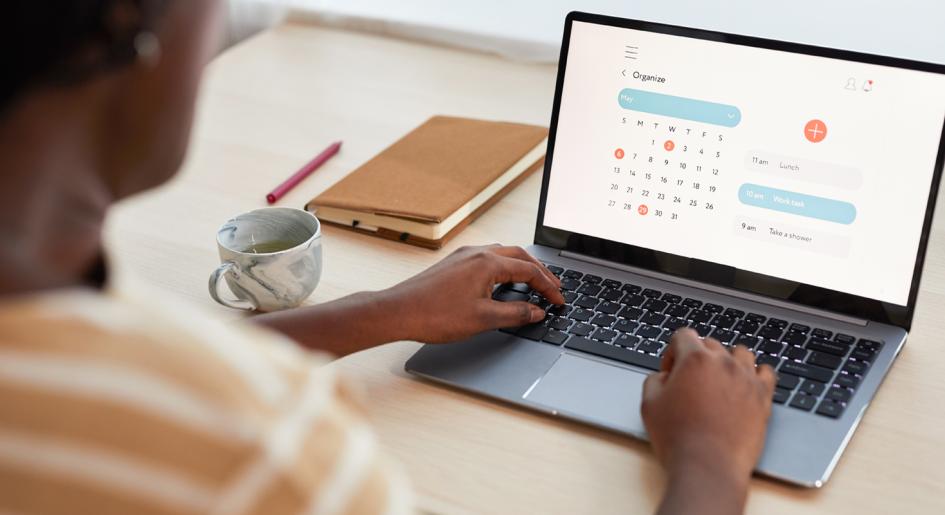 Person at laptop looking at calendar
