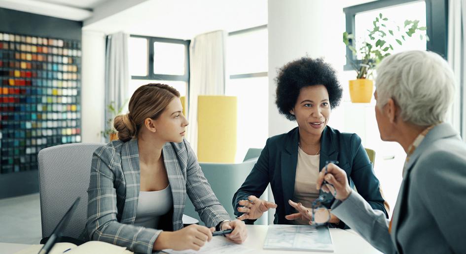 Law school administrators sitting at table conversing