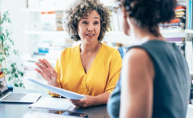 A prelaw advisor speaks with a student