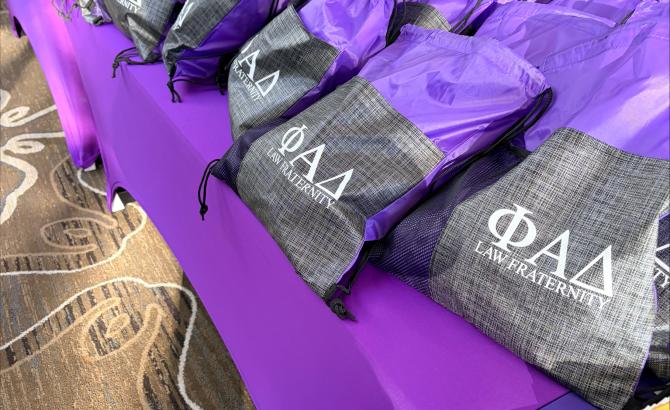 A row of bags sitting on a table. The bags say "PAD".